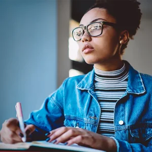 An image of a nursing graduate intensely studying, focused on UWorld NAPLEX prep