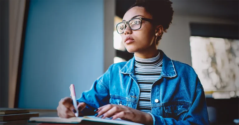 An image of a nursing graduate intensely studying, focused on UWorld NAPLEX prep